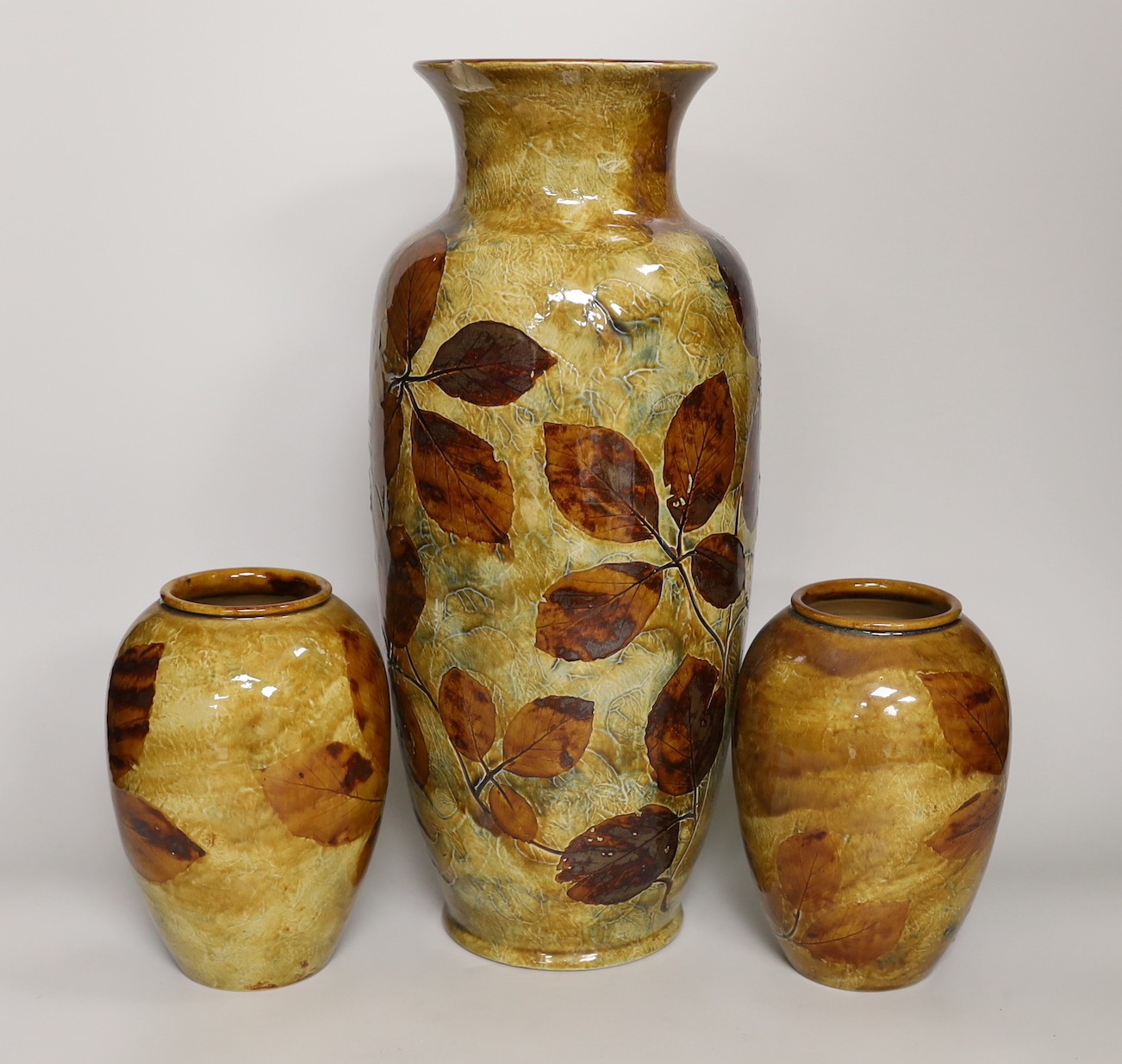 Royal Doulton Natural Foliage Ware - a pair of vases and a larger vase, larger vase 40cms high